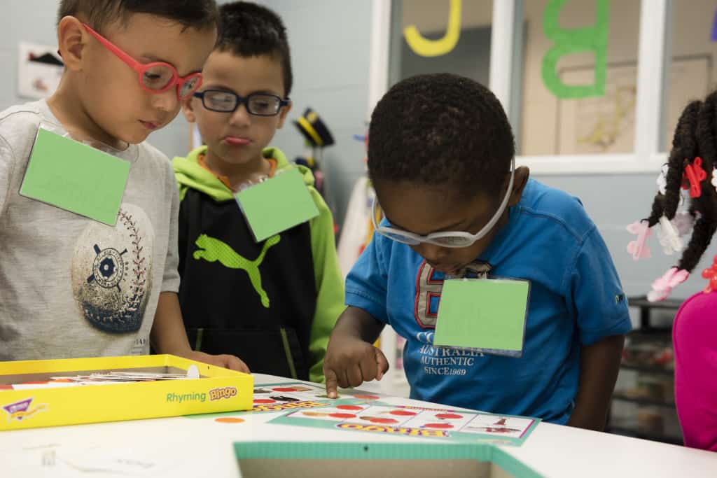 3 boys who are visually impaired play BINGO in preschool