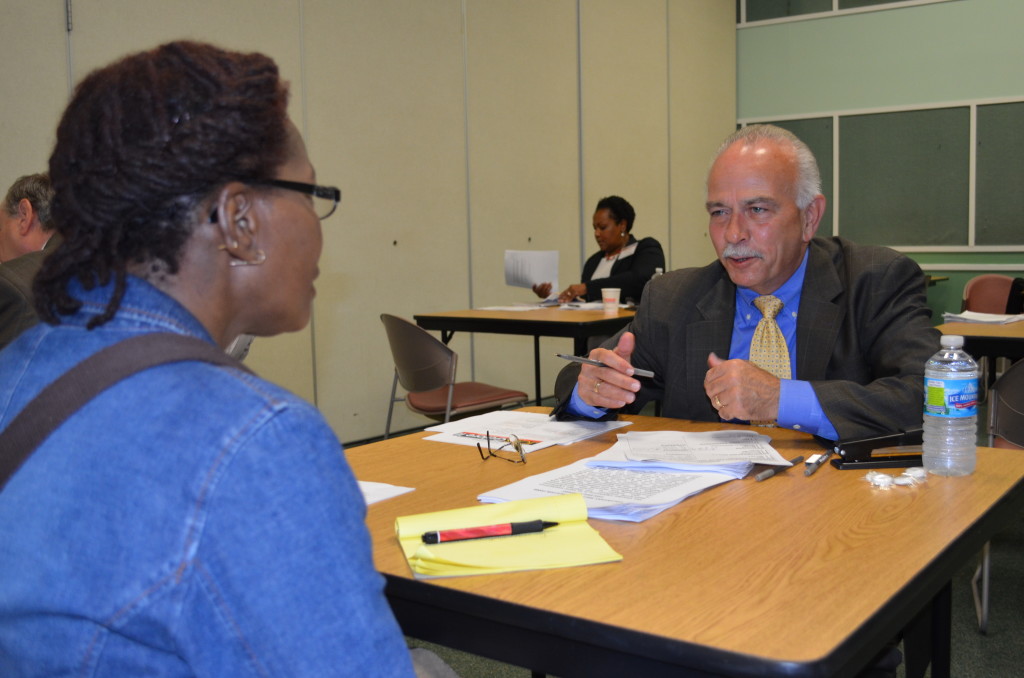 Lighthouse Board Member, Jack Stonebreaker practices interviewing skills with a visually impaired woman