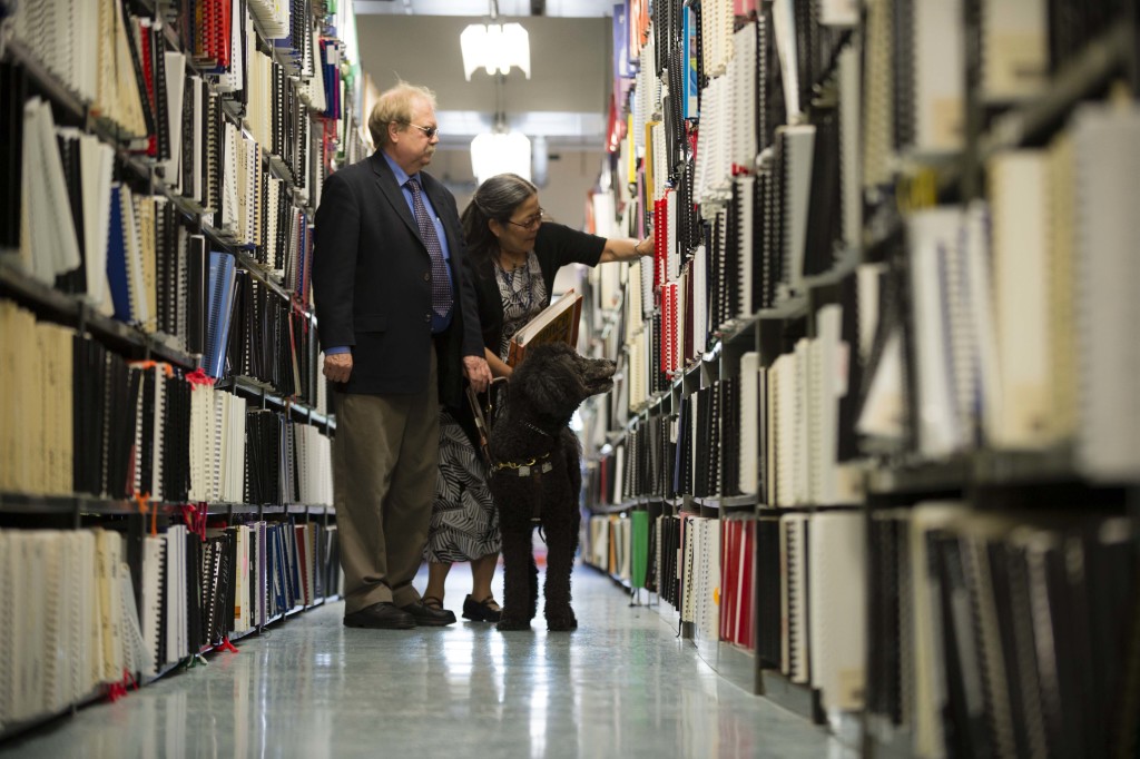 Employees of the IIMC browse the Braille textbook aisles