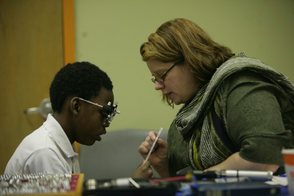 A student is evaluated for glasses by low vision optometrist, Tracy Matchinski