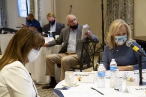 Board members, with face masks conduct a Board Meeting via Zoom