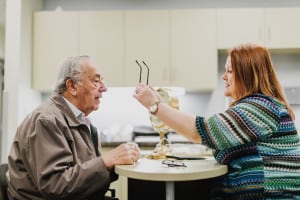 An older man is fitted for glasses by a technician