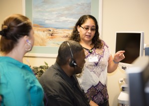 A man is instructed on using assistive technology in the Transitional Jobs Program