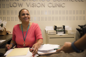 A patient is greeted with a warm smile by the receptionist