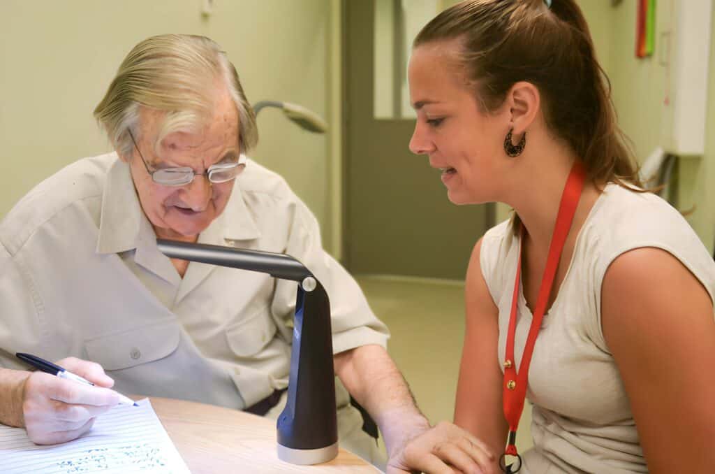 A woman is being trained on how to use assistive technology 