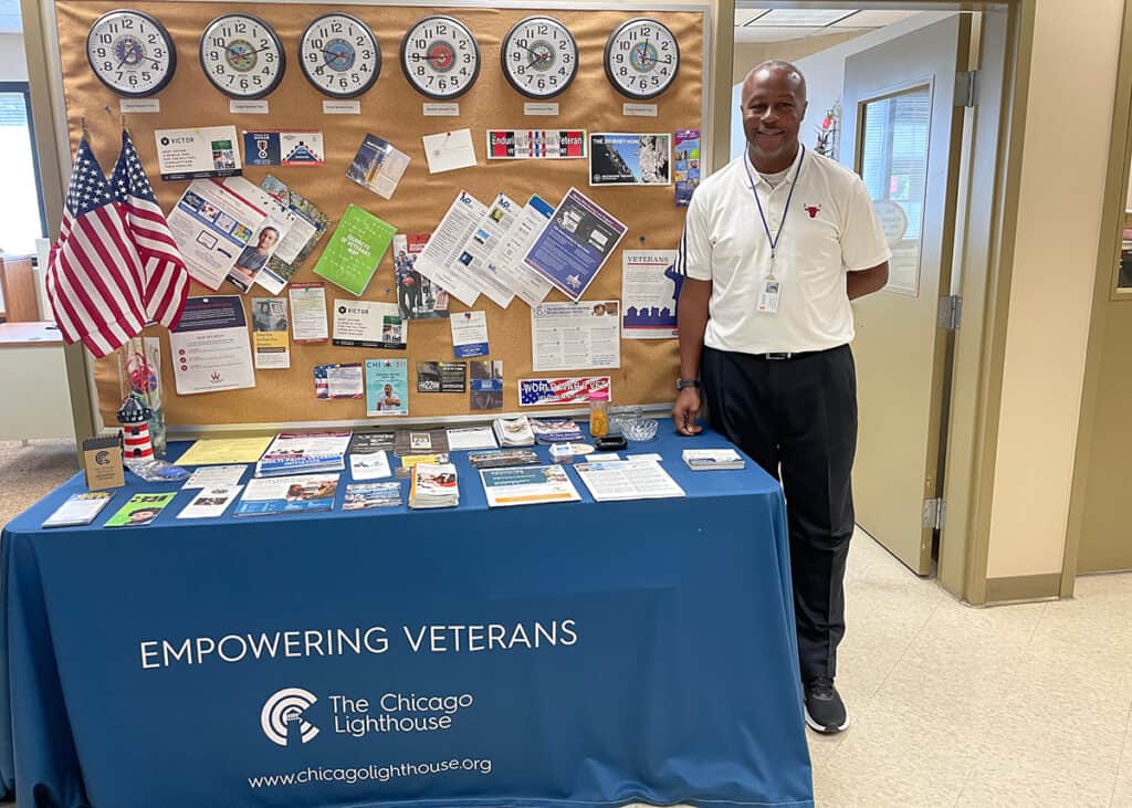 Learnus Ross Posing in front of Veterans literature 