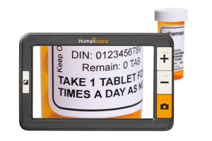The explore 5 is seen in front of bottle of pills, which shows magnified on its screen.