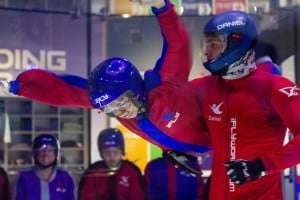 A participant and instructor indoor skydiving