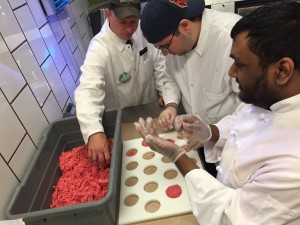employees who are blind learn to make meatballs using a template for consistent sizing