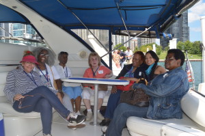 a lovely group of the yacht participants and volunteers pose in the back of Captain Cookie's yacht