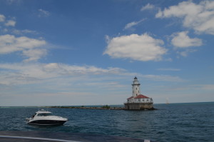 Photo of the actual lighthouse out on Lake Michigan and a yacht from the Chicago Yacht Club with Chicago Lighthouse passengers