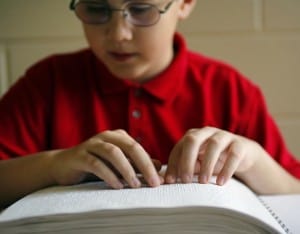 child reading Braille