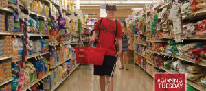 A teenage boy who is visually impaired navigates the grocery aisle with the use of his white cane
