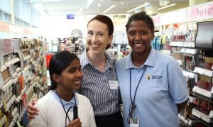 A manager at Walgreens poses with 2 interns, one who is blind and one who is visually impaired