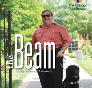 Bill Jurek and his guide dog pose in front of Lighthouse garden in a vintage cover photo for the Fall 2017 Beam publication