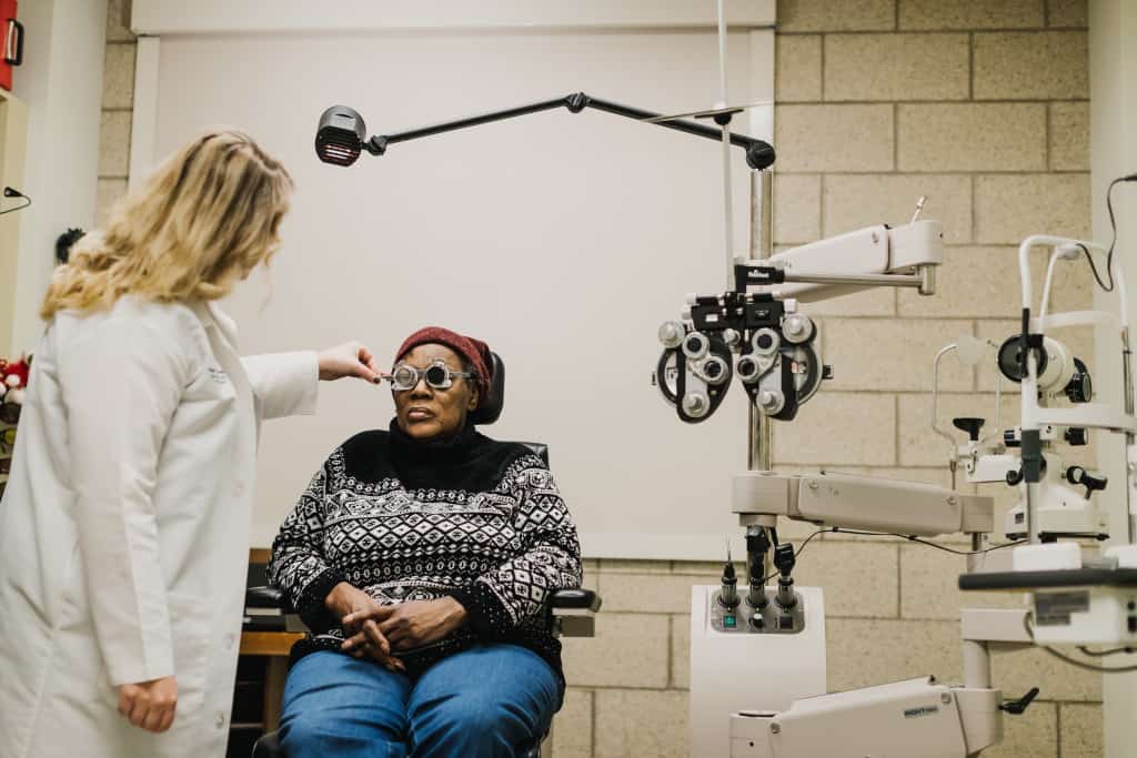 A doctor in The Chicago Lighthouse Low Vision Clinic works with a patient. 