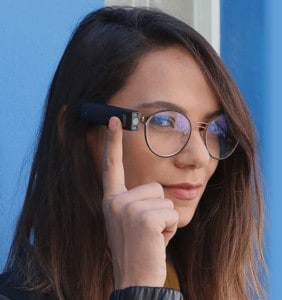 A model shows the MyEye 2.0 OrCam device on the side of a pair of eye glasses she is wearing