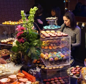 Guests choose desserts from a towering, colorful sweets table.