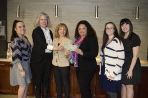 Members of the Chicago Lighthouse hold a StateFarm check