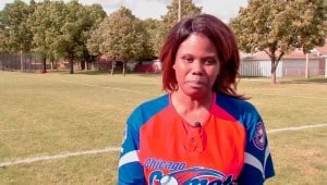 Kalari Girtley, standing in a field wearing a Chicago Comet's baseball jersey