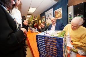 Author Larry Broutman along with Illustrator Rich Green autograph books at the launch of Chicago Treasure