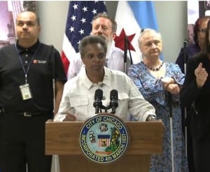 Mayor Lori Lightfoot conducts a press conference at The Chicago Lighthouse. Several members of the blind/visually impaired communtiy are standing behind her.