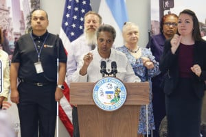 Mayor Lori Lightfoot delivers remarks for a press conference held at The Chicago Lighthouse. Behind her are several members of the blind and deaf community