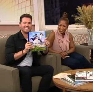 Scene from Windy City Live interview with Larry Broutman. Co-host Ryan Chiaverini holds up the book Chicago Treasure