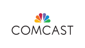 A photo of the Comcast Logo featuring the NBC Peacock above the words Comcast.