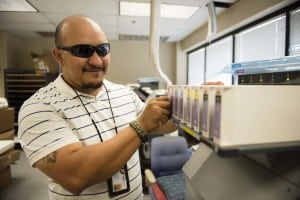 Ivan, who is visually impaired, works in the Printshop of Chicago Lighthouse Industries where over 6 million clocks have been made to date.