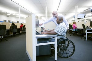 Call center employee in wheelchair working at a desk