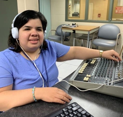 Sandy uses audio engineering equipment in her job at The Chicago Lighthouse's CRIS Radio.