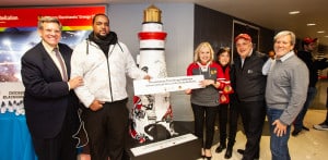 Chicago Blackhawks owner Rocky Wirtz is presented with a 6' tall lighthouse sculpture that was painted with Blackhawk players on it. Presenting the sculpture are the artist, Hamaz, Lighthouse President/CEO Janet Szlyk, Julie Stark, Rabi Steven Lowenstein and Gary Rich