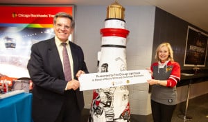 Chicago Blackhawks Owner Rocky Wirtz is presented with the Lighthouse on The Mag Mile sculpture: One Goal, by Lighthouse President/CEO Dr. Janet Szlyk.