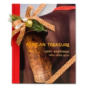 African Treasure book with giraffe print ribbon and bell tied around