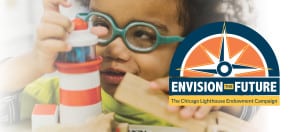 A preschool boy who is visually impaired looks closely at a lighthouse toy through his green glasses