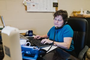 Maureen Reid, Job Placement Counselor and Scholarship Coordinator of The Chicago Lighthouse's Employment Services, working at her computer