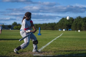 Image of Kalari swinging the bat during a beep baseball game