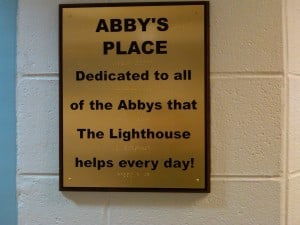 gold plaque that reads: abby's place. Dedicated to all of the Abbys that The Lighthouse helps every day!