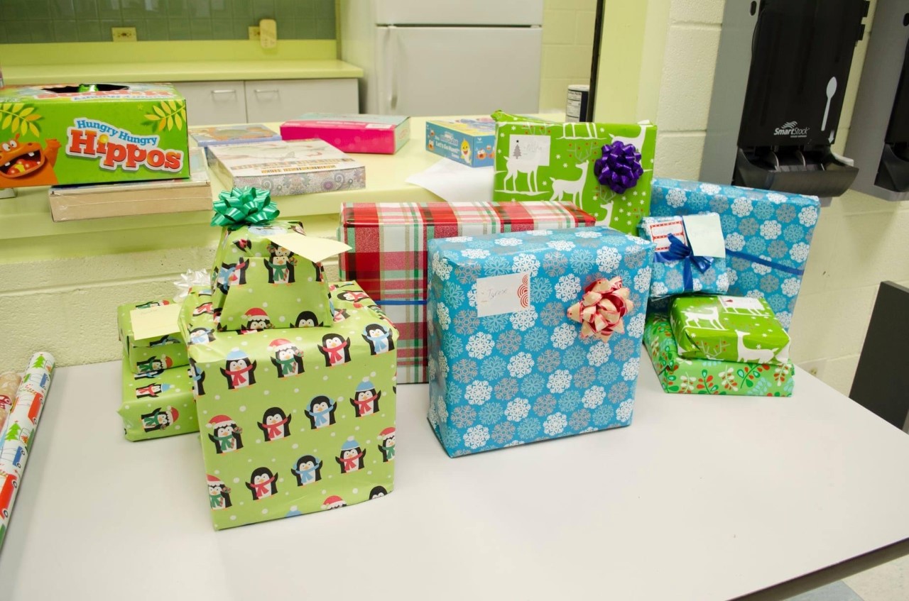 several brightly colored wrapped gifts set on a table