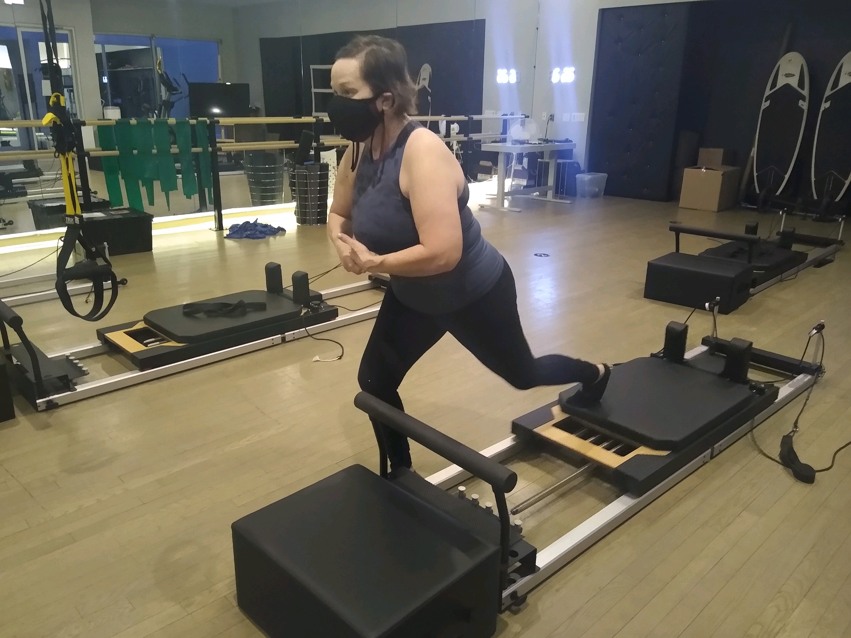 Brooke working out on a machine in a gym