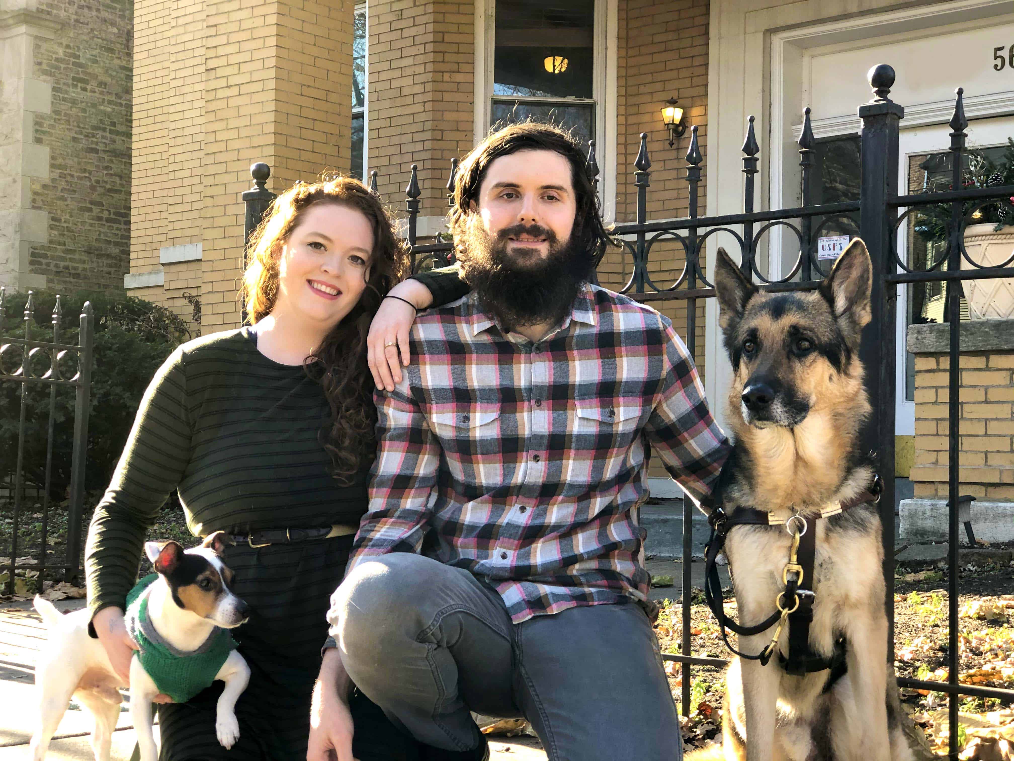 Ben, his wife Martha, and their dogs Louie and Sammie in front of their new home