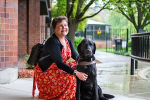 Maureen is pictured alongside her guide dog, Gaston.