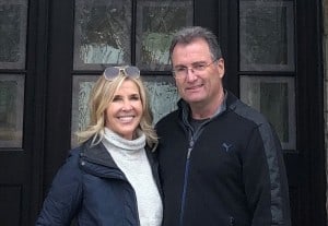 Photo of David and Nancy Huber outdoors in front of their home