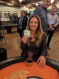 Laura Dorn holding her winning cards, 8 of Clubs and 5 of Spades