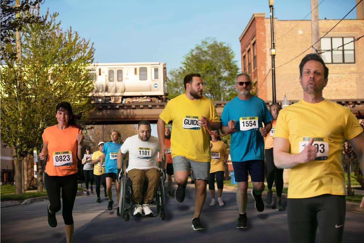 A group of people with various capabilities participating in the Rise to Shine Race