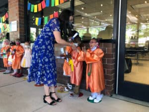 CLH Preschool student accepts her diploma