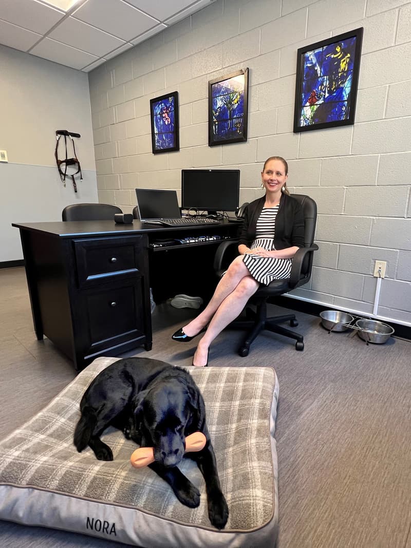 Colleen and her guide dog Nora in her office