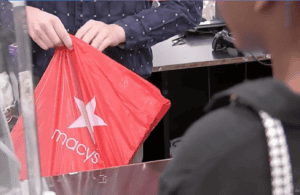 macys bag being handed to a visually impaired shopper