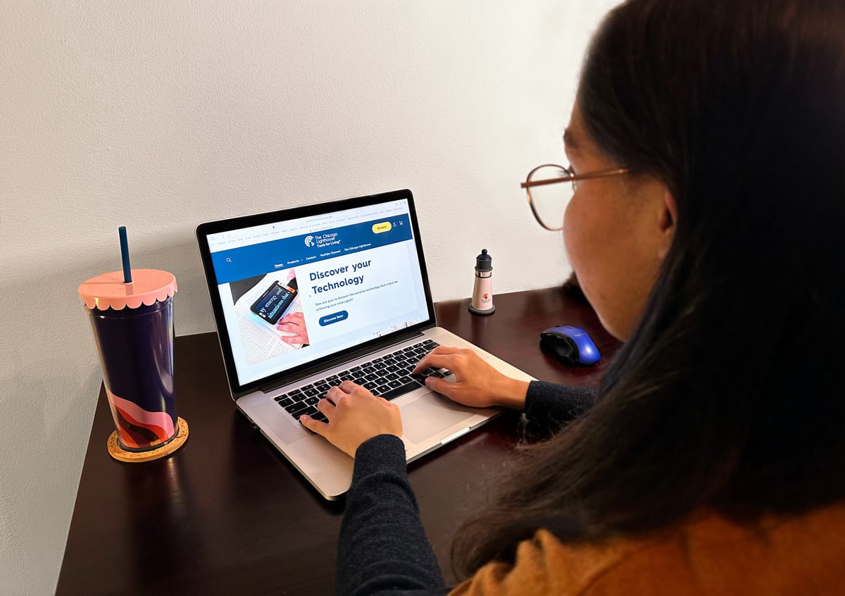 Woman browses the new "Tools for Living" Store website on her laptop